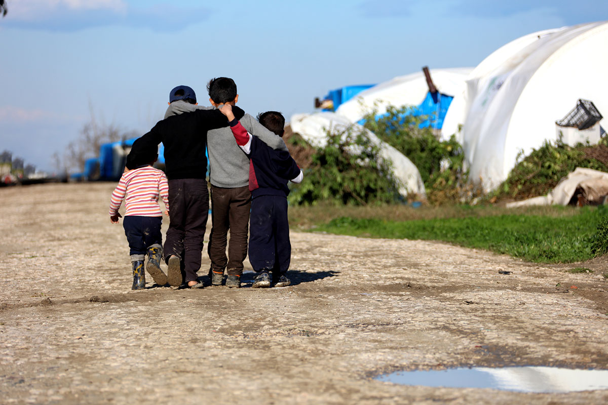 a group of children walking in arms