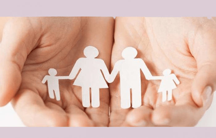 hands holding cut out paper people