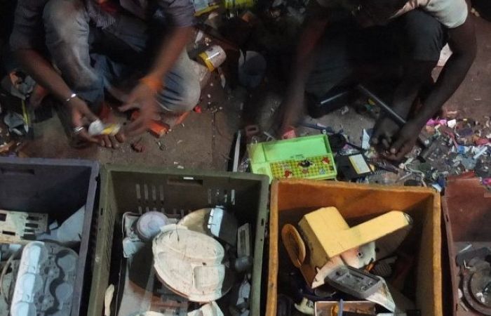 a photo from above showing two men separating recycling